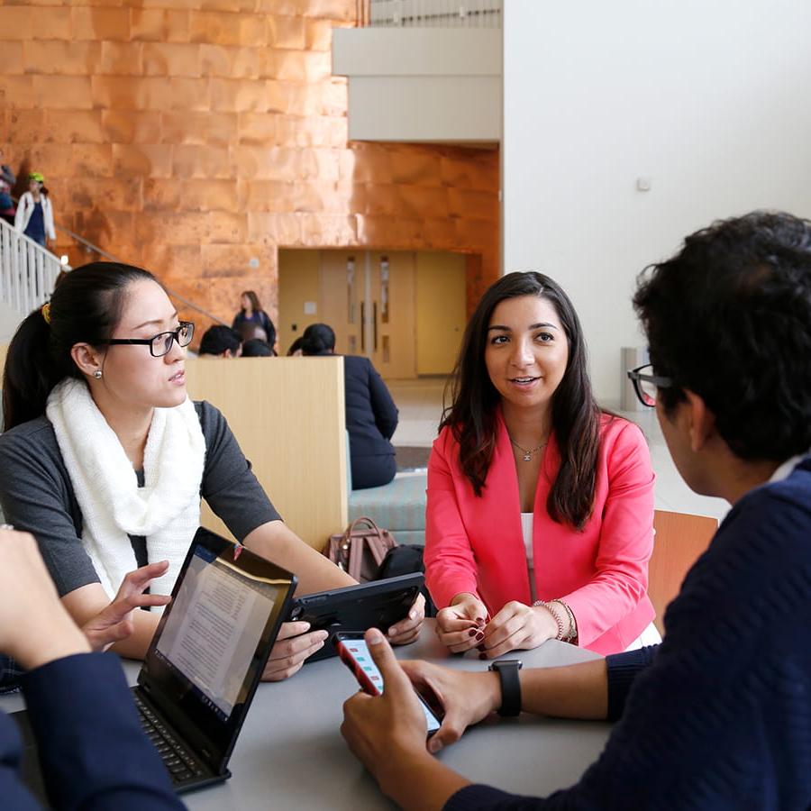 Group of business students meet at table in University Hall.